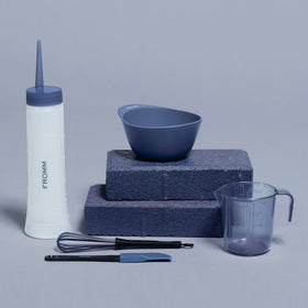 Fromm bottle held in hand for size scale and ergonomic squeeze dispensing advantage