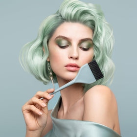 Fromm brush in stylist hand applying color demonstrating fast, controlled coverage