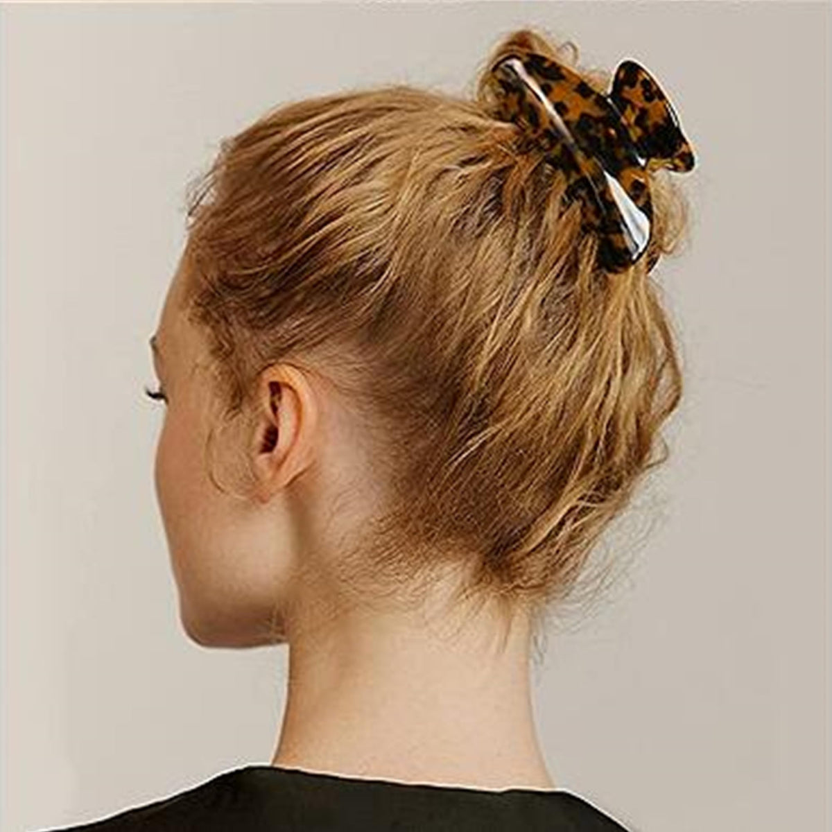 Fsmiling clip securing a high bun, fast salon-quality updo benefit