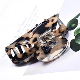 Fsmiling clips styled with beach outfit showing travel-friendly, fashionable accessory