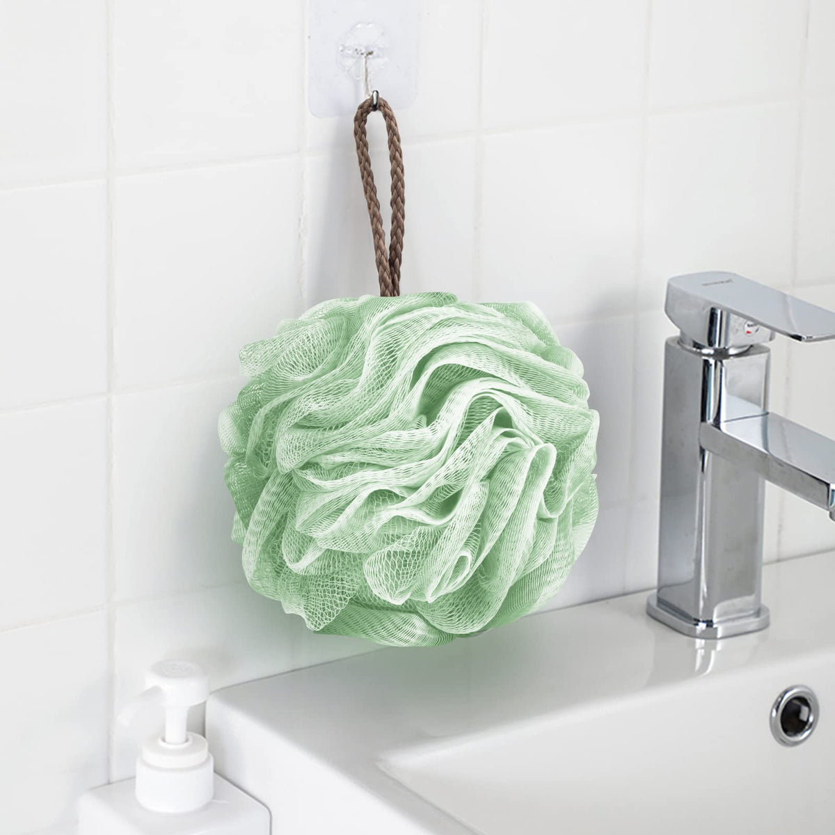Fu Store loofah next to hand showing size and comfortable grip
