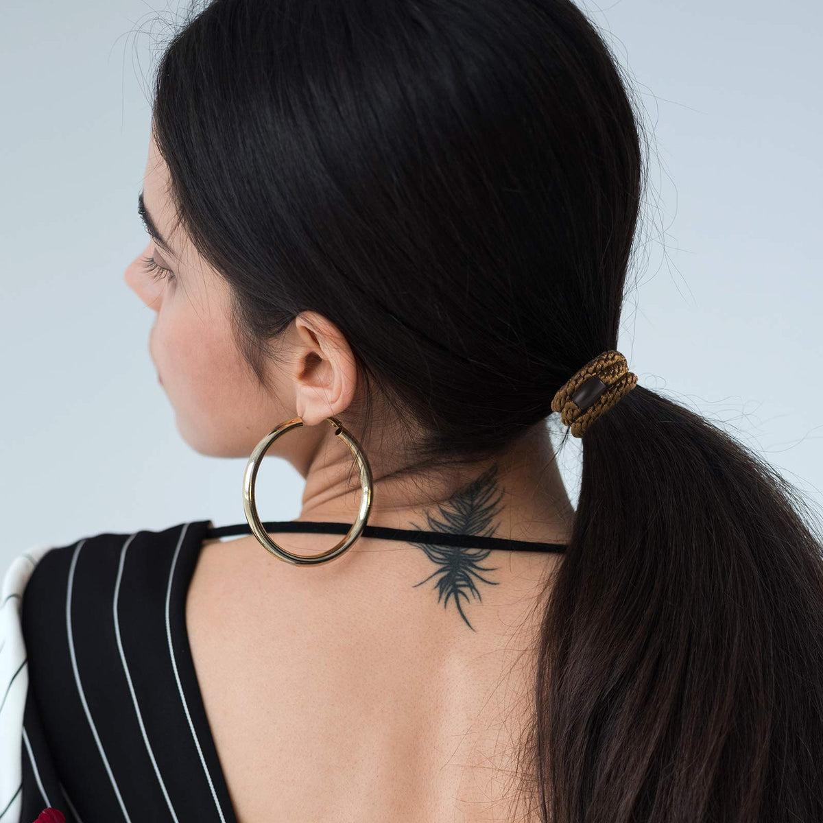 Funtopia lifestyle shot of woman tying hair demonstrating gentle no-crease hold