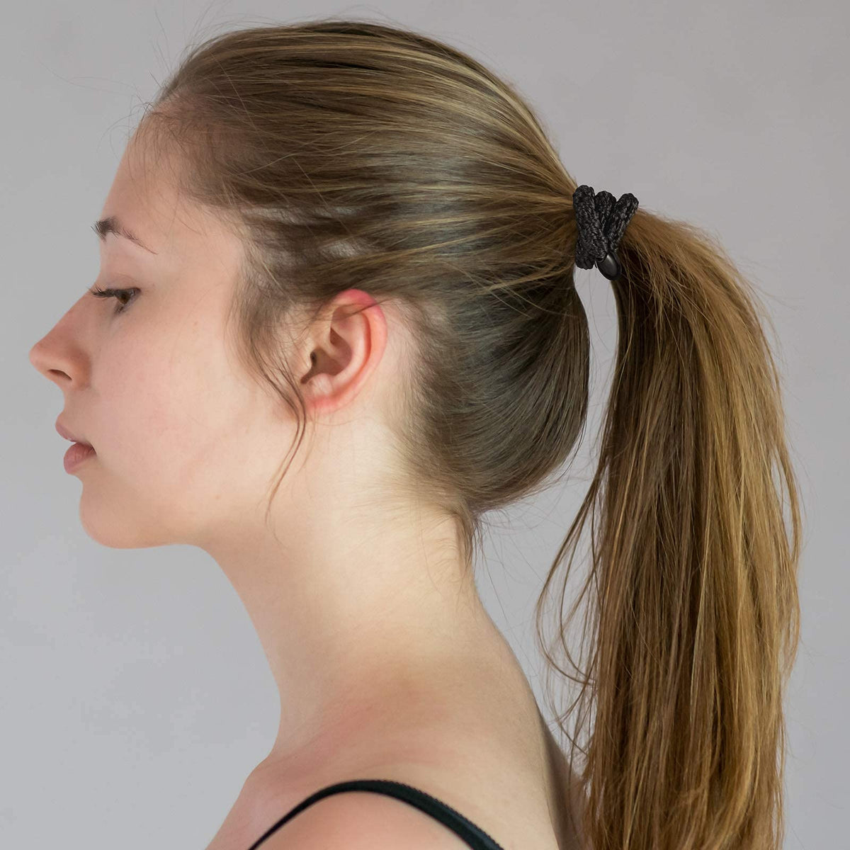 Funtopia hair ties beside a ruler and hand showing size and generous stretch benefit