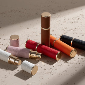 Fusupak atomizer tucked into a handbag pocket showing discreet travel-ready carry