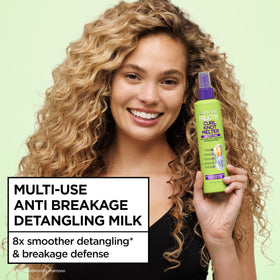 Garnier Fructis bottle in hand to illustrate travel-friendly size