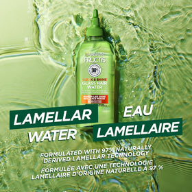 Garnier bottle held in hand showing 6 fl oz scale for size reference