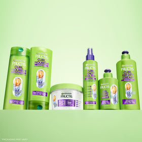 Garnier Fructis conditioner on bathroom shelf paired with curl care products