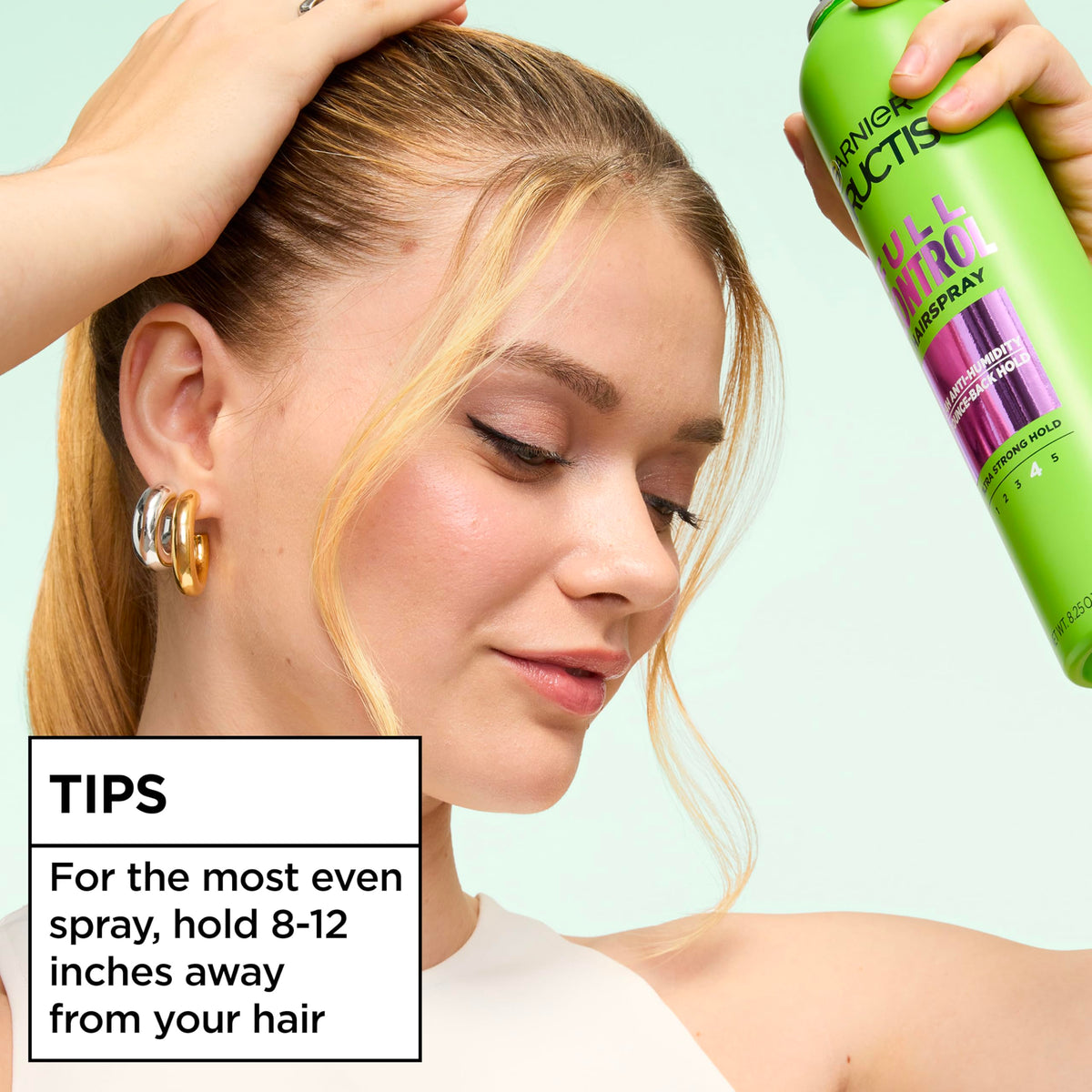 Garnier Fructis used outdoors showing humidity-resistant hold benefit