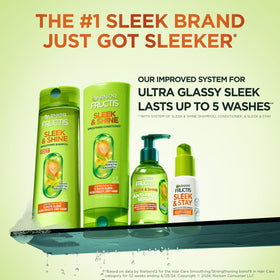 Garnier Fructis scale comparison hand holding bottle showing travel-friendly size