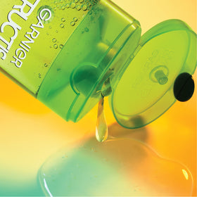 Garnier Fructis bottle held in hand to show 33.8 fl oz size and value