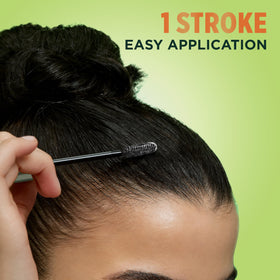 Garnier Fructis next to lipstick showing compact travel-friendly size