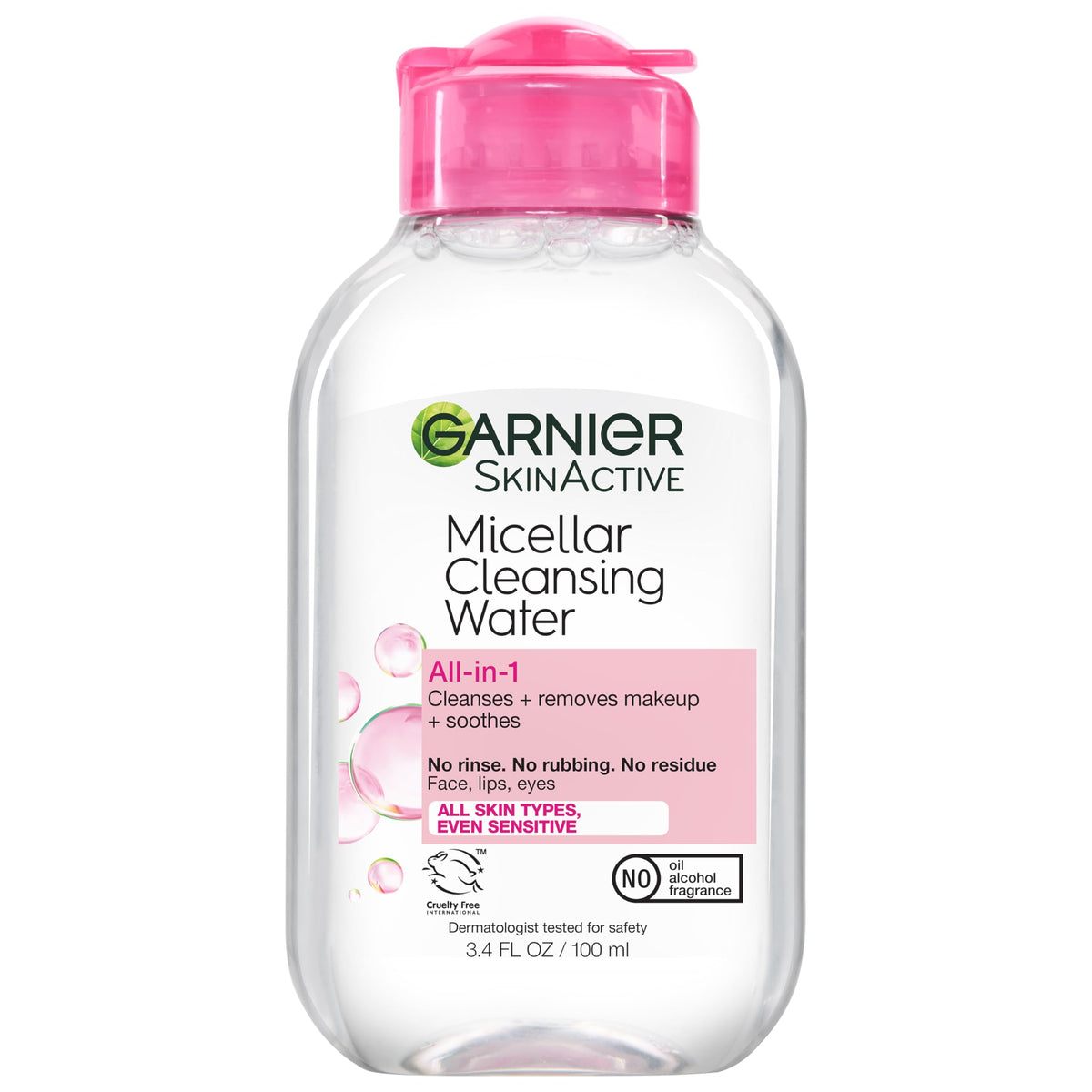 Hand holding Garnier mini bottle to show scale and easy travel convenience