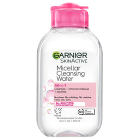 Hand holding Garnier mini bottle to show scale and easy travel convenience