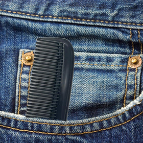 G.B.S comb beside a credit card illustrating compact size