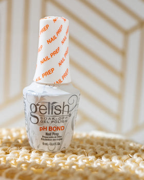 Gelish MINI pH Bond held in hand to show compact travel-friendly size