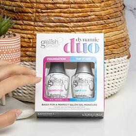 Gelish set in use in a salon with technician applying base for durable adhesion