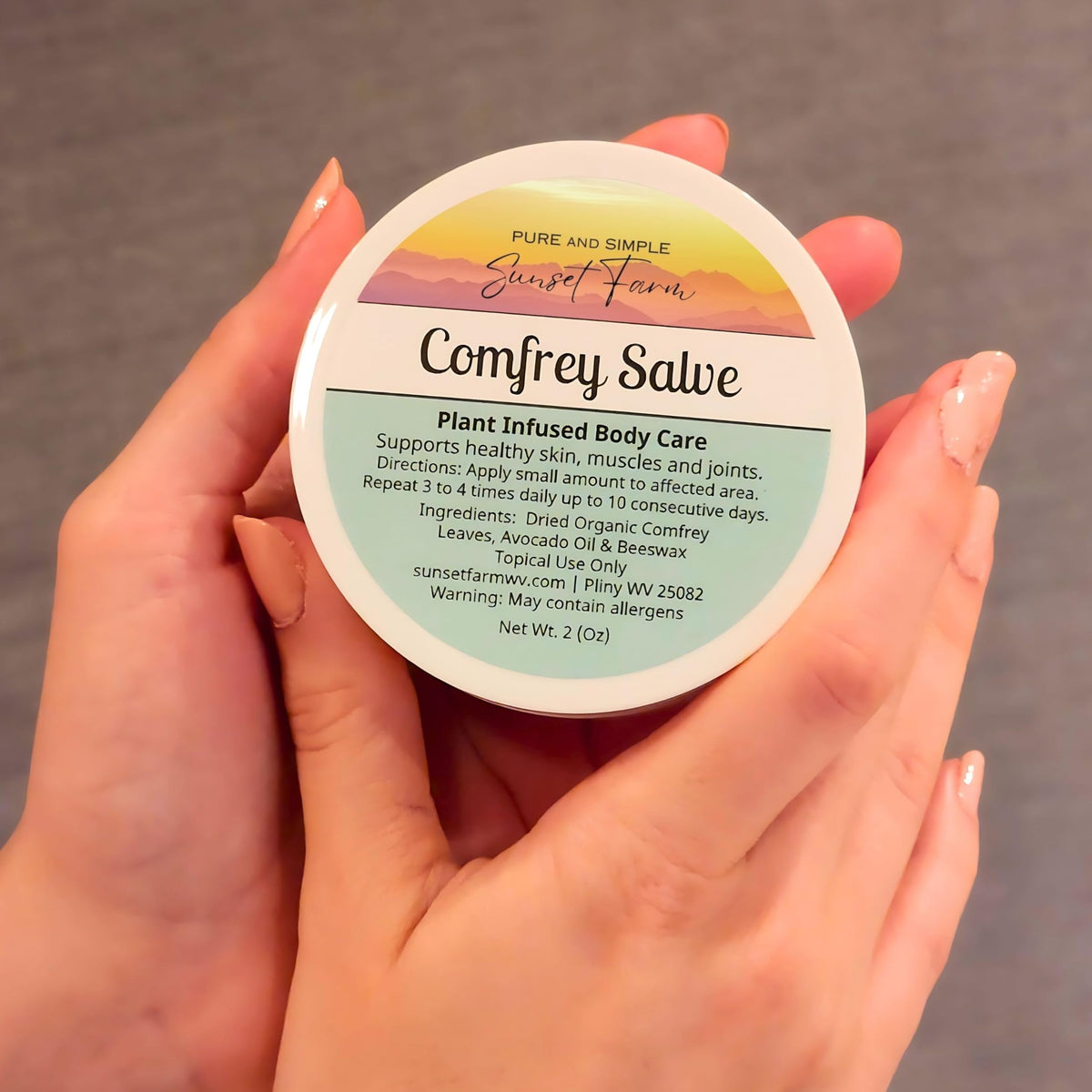 generic comfrey salve farm harvest photo with comfrey leaves and family farm setting conveying organic sourcing