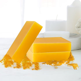 Generic lemon turmeric soap in hand showing size and easy travel-friendly benefit