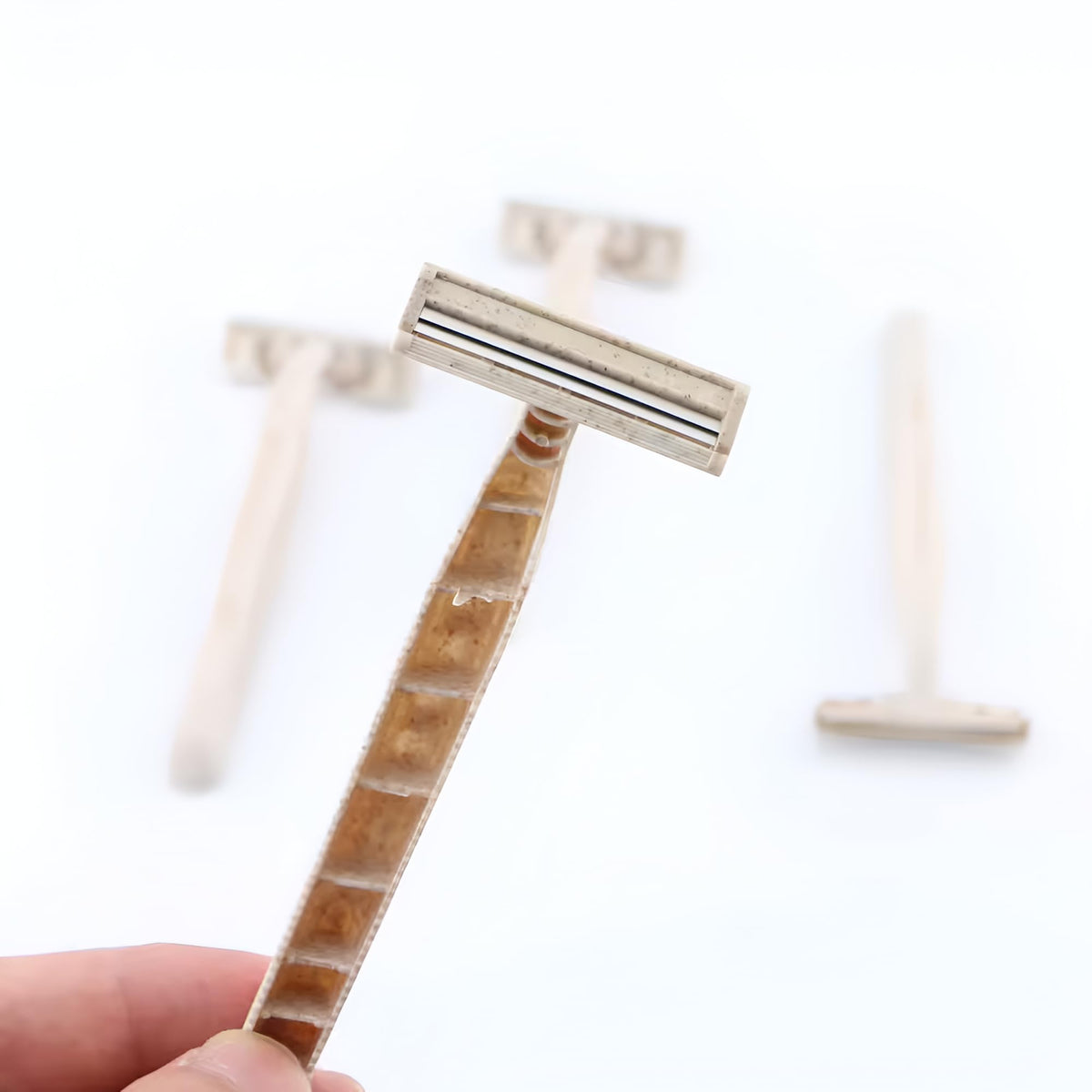 Generic separated razor parts showing compostable handle and recyclable blade