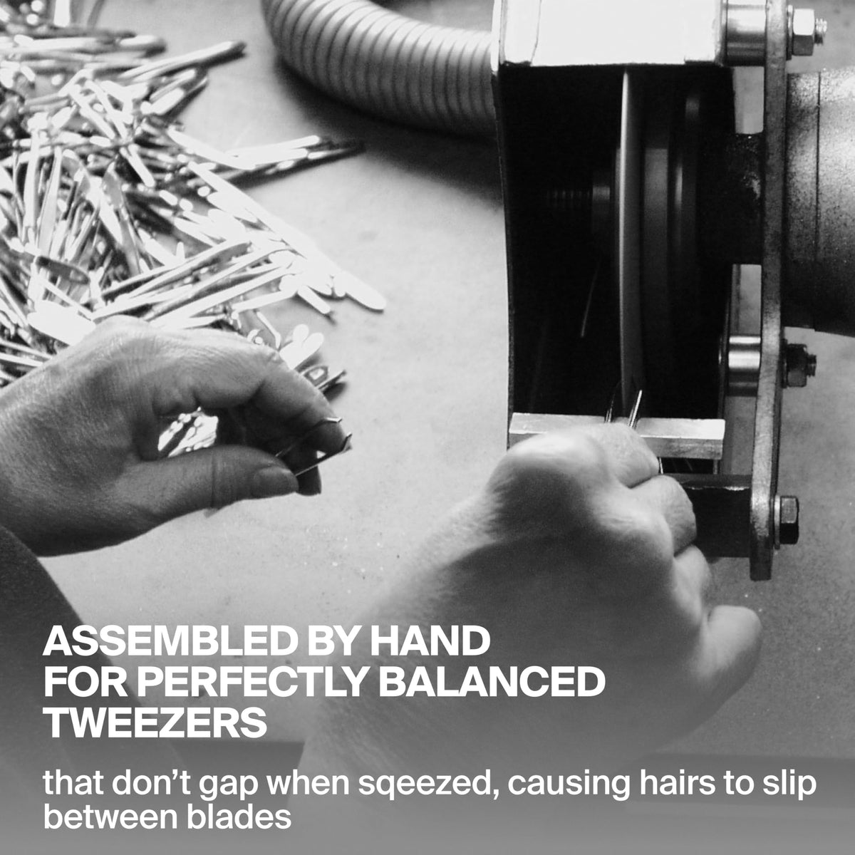 GERmanikure tweezers held in hand demonstrating scale and ergonomic comfort