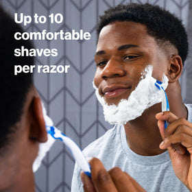 Gillette SkinGuard razor in hand to show scale and easy grip for safer shaving