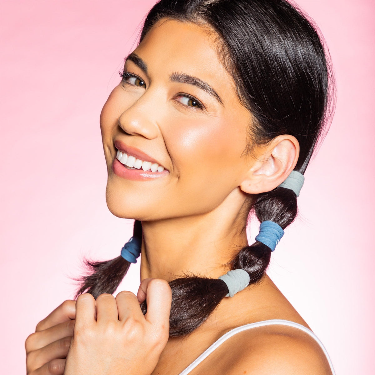 GIMME lifestyle photo of woman tying hair showing comfortable all-day wear benefit