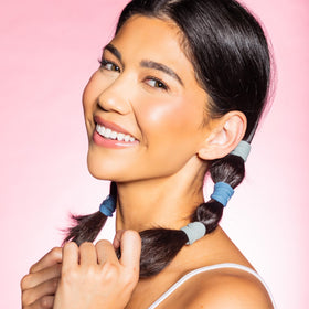GIMME lifestyle photo of woman tying hair showing comfortable all-day wear benefit