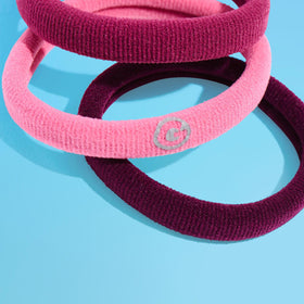 GIMME band held in hand showing low-profile size and stretch
