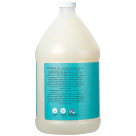 Ginger Lily Farms pouring shampoo into dispenser demonstrating bulk refill convenience