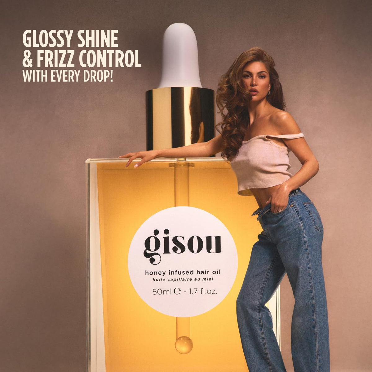 Applying Gisou to hair ends demonstrating frizz control and smoothness