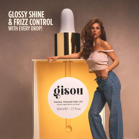 Applying Gisou to hair ends demonstrating frizz control and smoothness