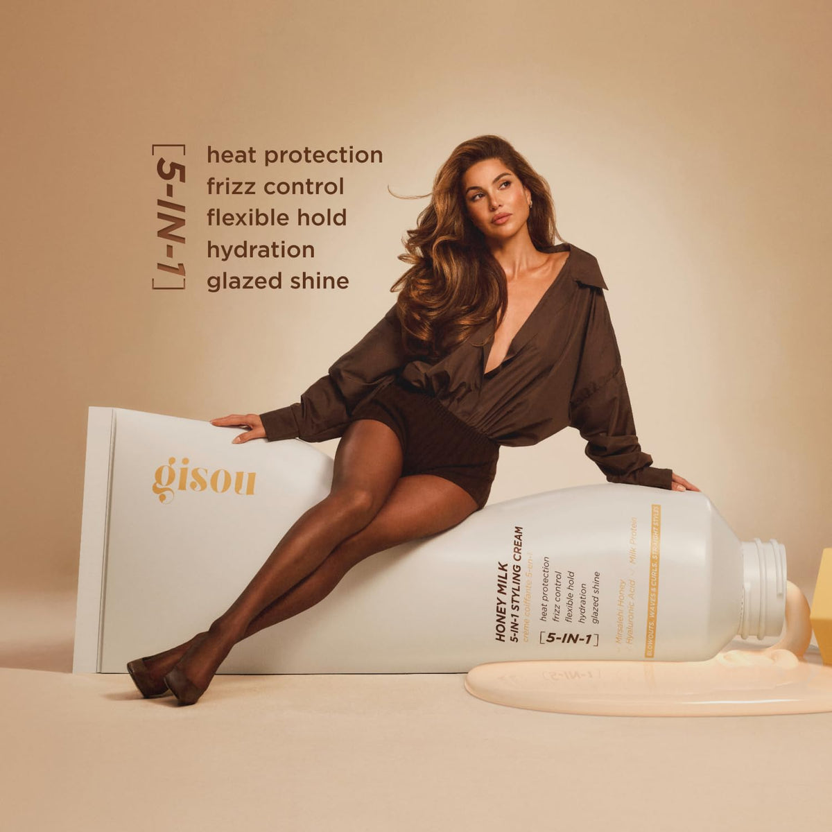 Gisou bottle in hand for scale showing travel-friendly 5 fl oz