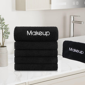 GLIMGLINT towel held in hand to show 13x13 inch scale and easy portability benefit