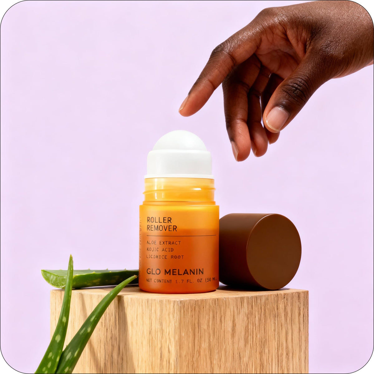 Glo Melanin bottle with botanicals in background emphasizing soothing natural extracts