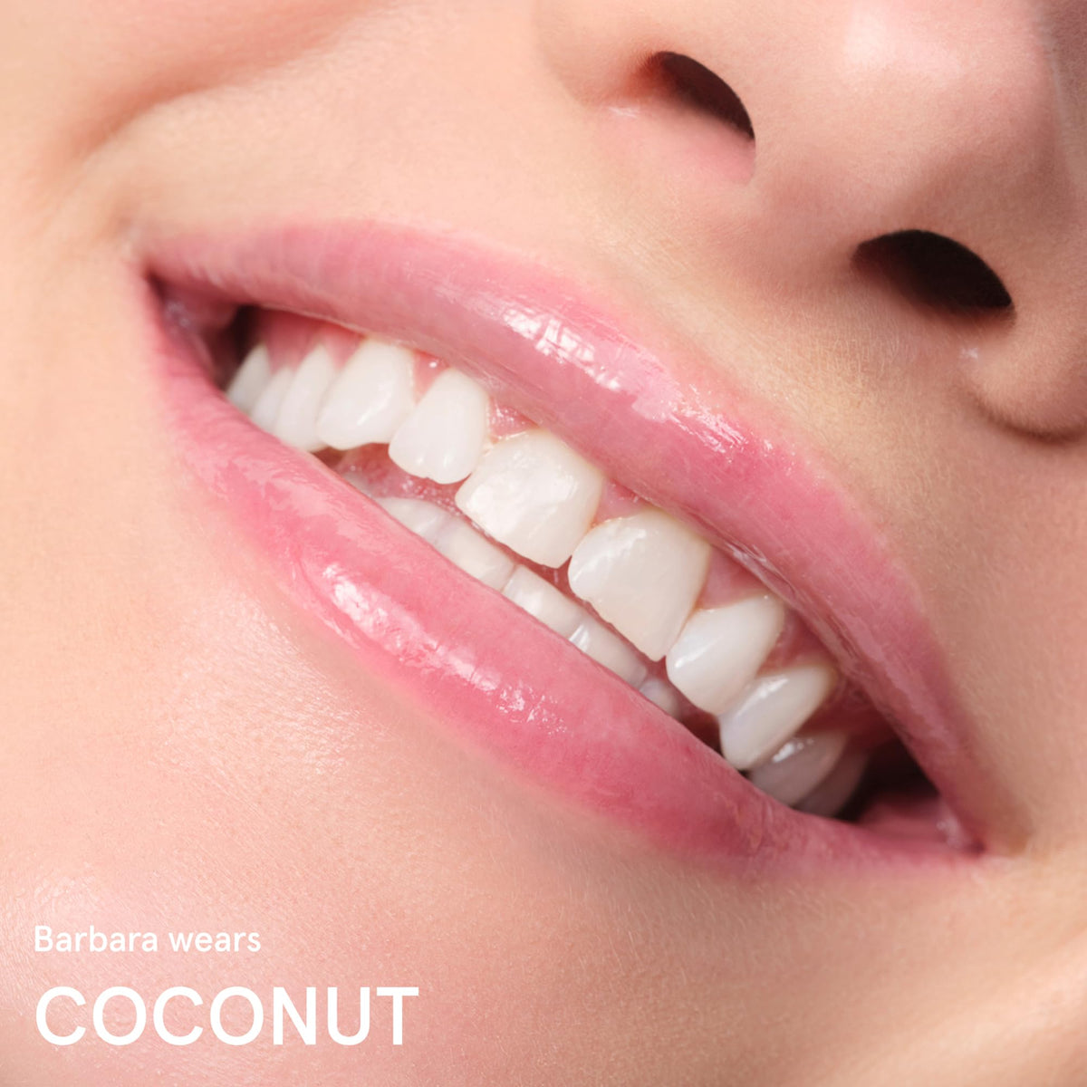 Glossier Balm Dotcom on lips showing clear gloss finish and non-tinted natural look