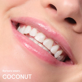 Glossier Balm Dotcom on lips showing clear gloss finish and non-tinted natural look