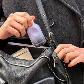 Glossier You Fleur inside a handbag showing convenience for on-the-go touch-ups