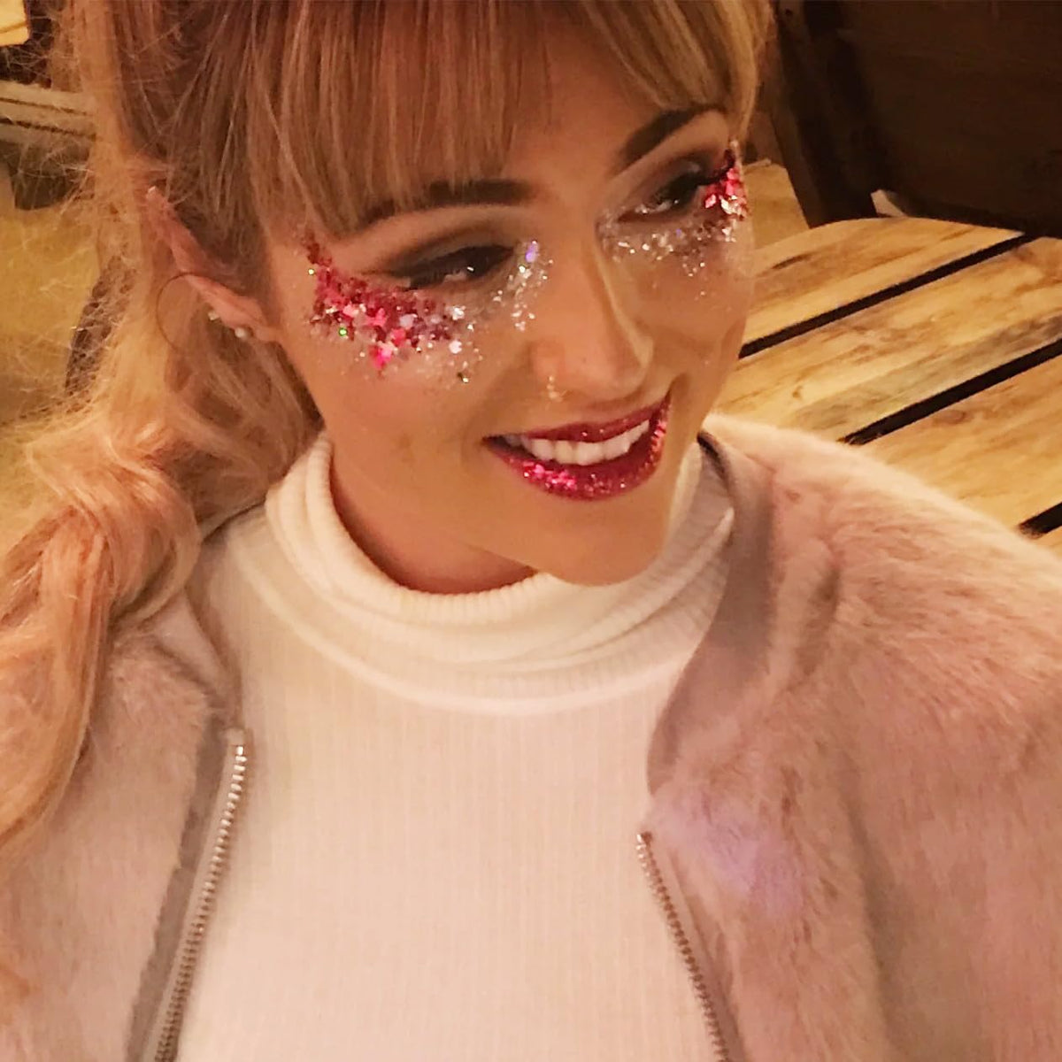 Go Ho glitter on lips and cheek, adds stage-ready red shimmer and dimension