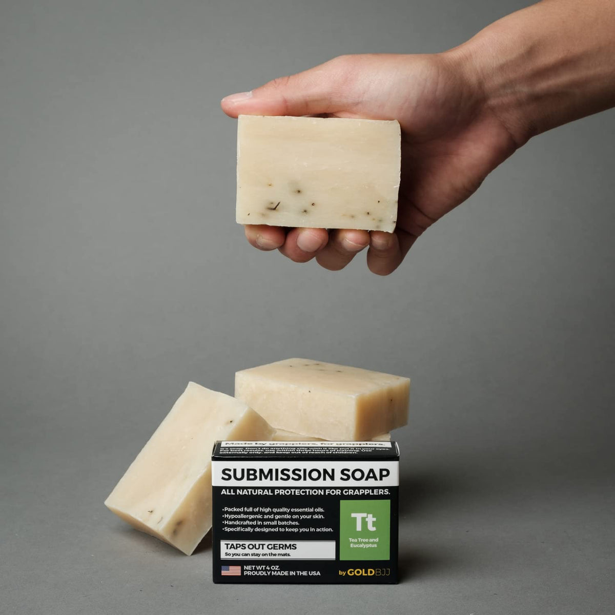 Gold BJJ activated charcoal tea tree bar showing deep-clean visual appeal