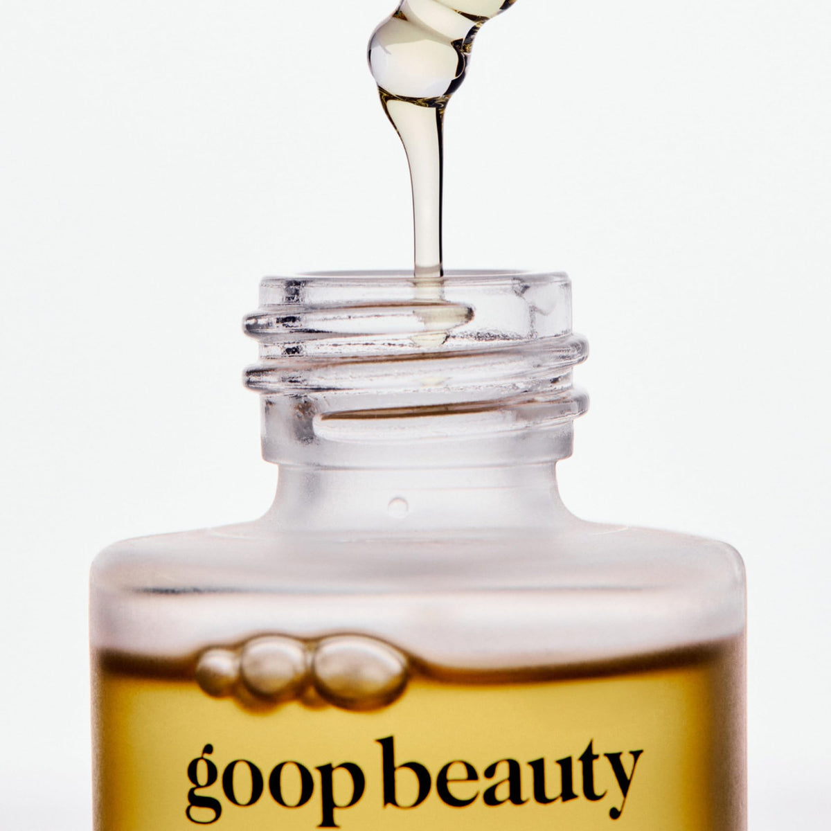 goop applying oil to neck and décolletage for smoother skin