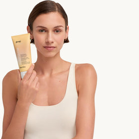 goop body polish in shower setting illustrating in-shower use and convenience