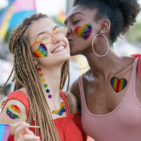 GOROMON lifestyle parade scene with people wearing multiple pride tattoos to show support