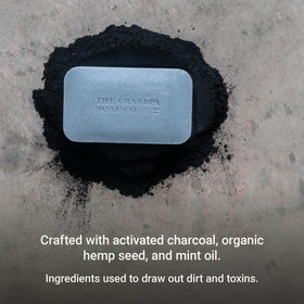 Lathered charcoal bar in hands demonstrating foam and gentle cleansing by The Grandpa Soap Company