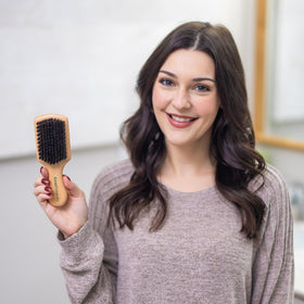 GranNaturals brush beside a comb showing compact size for travel