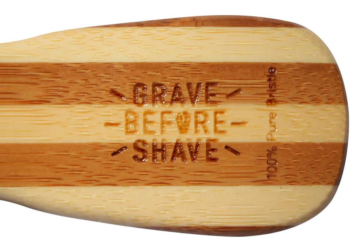 Grave Before Shave brush held in hand for scale, comfortable grip benefit