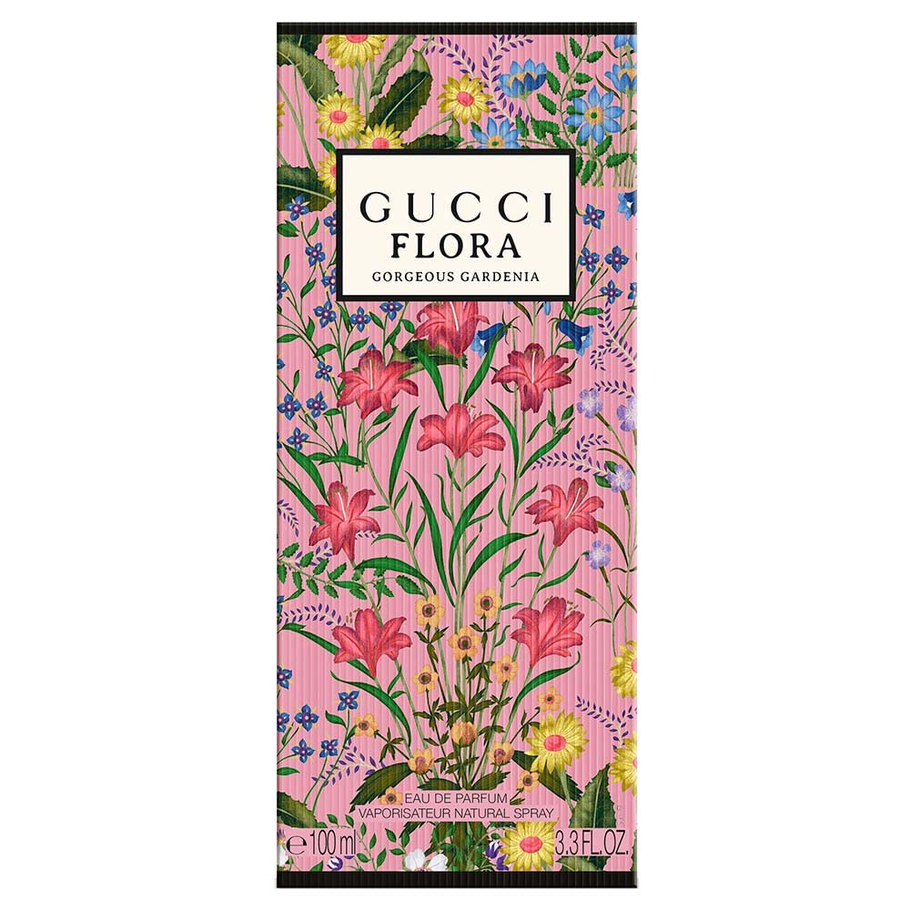 Gucci lifestyle image of perfume on scarf and flowers conveying wearable floral elegance benefit: versatile styling