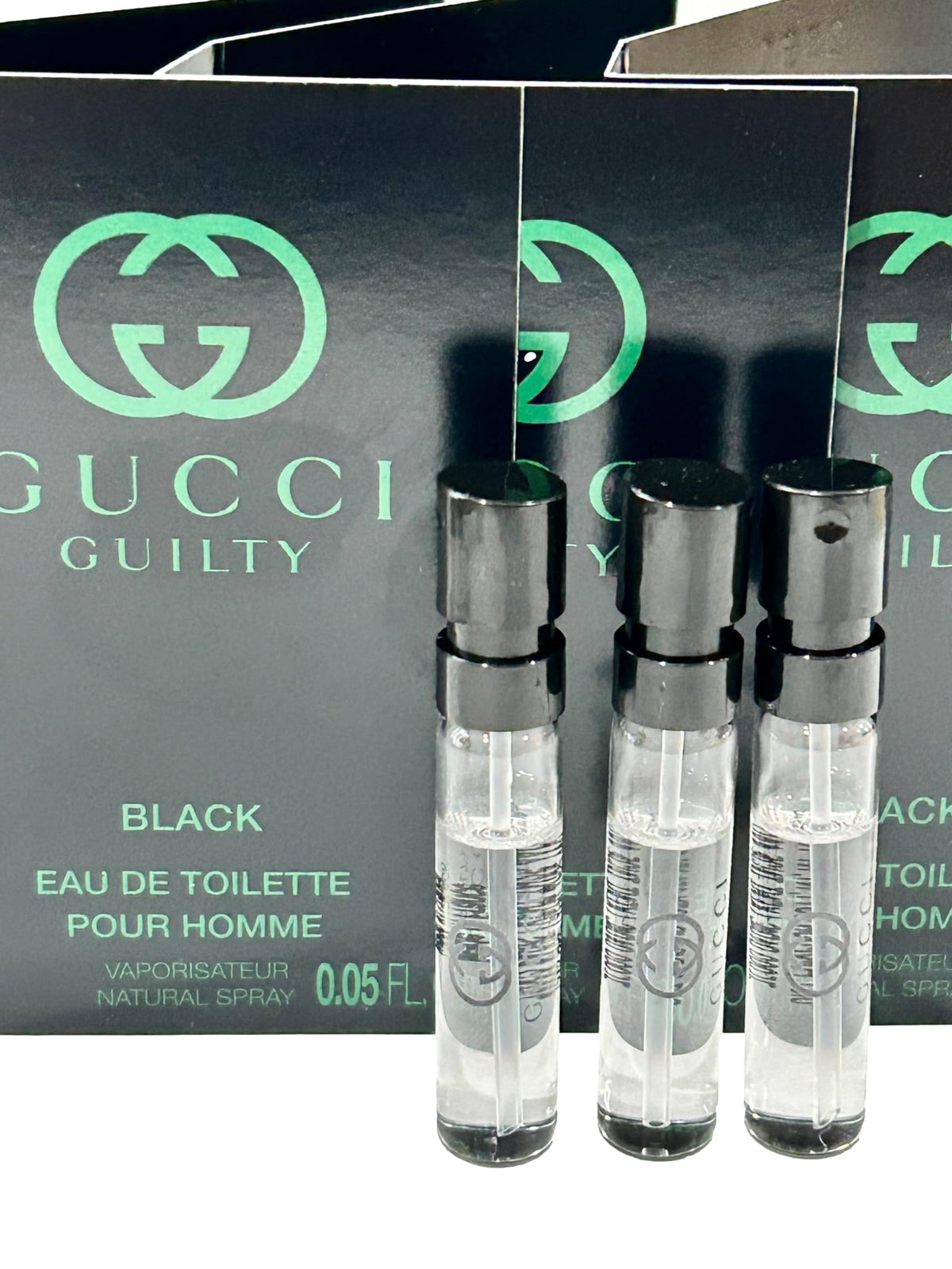Three Gucci Guilty Black mini vials arranged highlighting sample set convenience