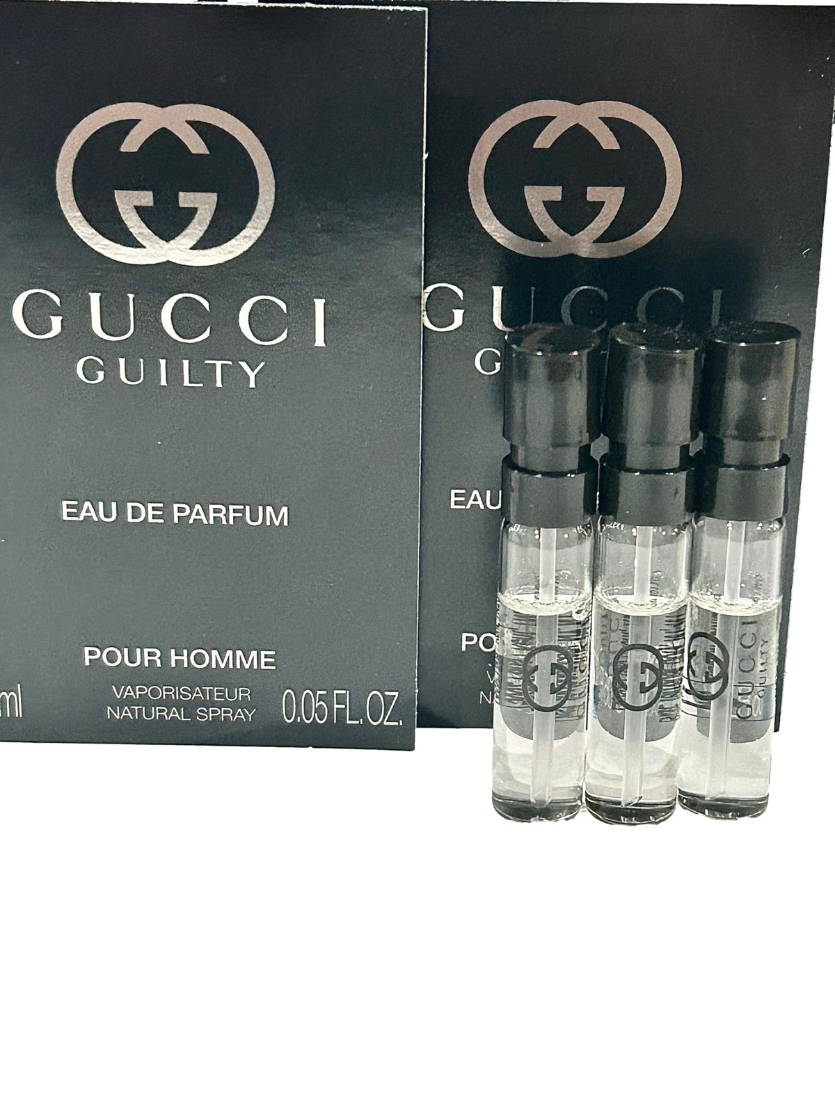 Hand holding Gucci Guilty 1.5 ml vial showing true size and easy portability for travel