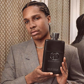 Gucci ingredient visual with cedar and patchouli emphasizing woody depth