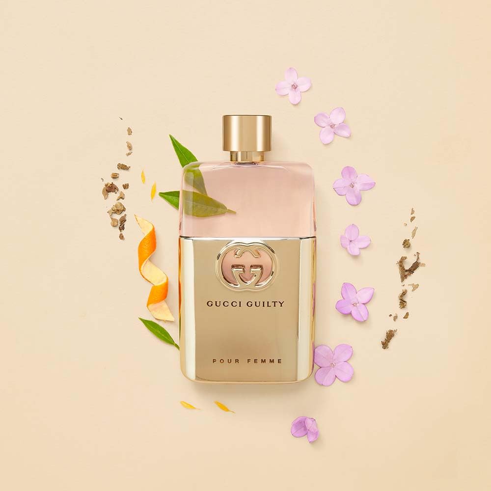 Gucci Guilty mist spray in use on wrist demonstrating easy application